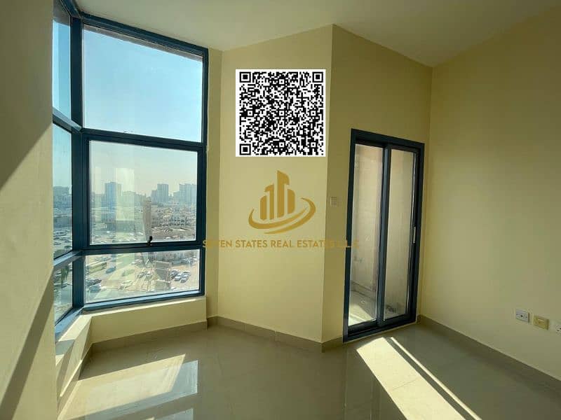 Studio apartment for sale in Al Nuaimiya Tower C, including parking, with an unobstructed view of Al Hikma School and Ramada Hotel, offering excellent