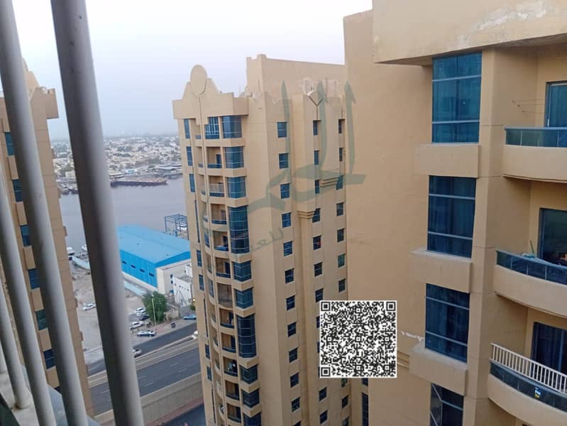 For sale: Two-bedroom apartment with a living room, 1800 sq. ft. , in Al Khawr Towers, Ajman, with an open view and a maid's room.
